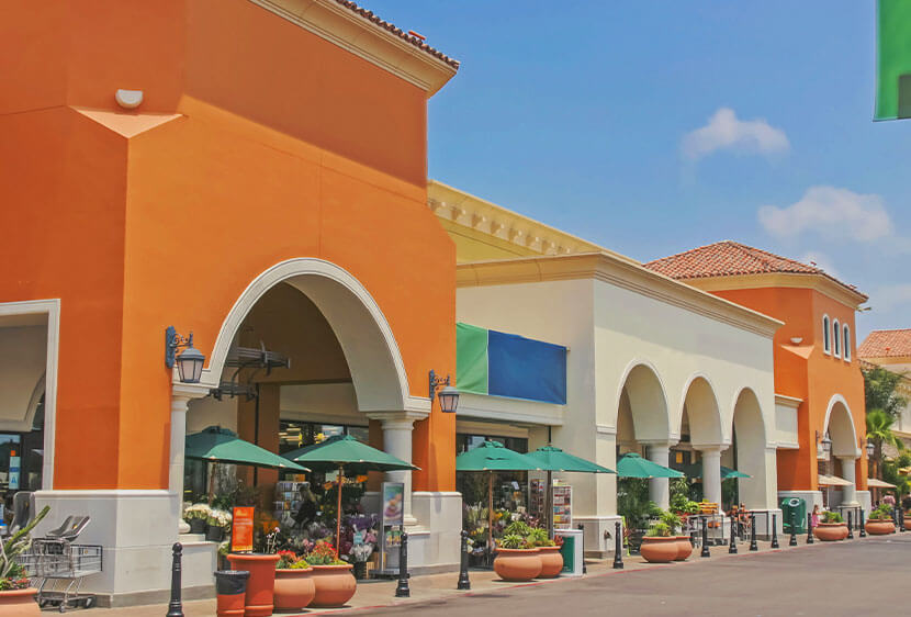 Storefronts at a shopping center during the day.