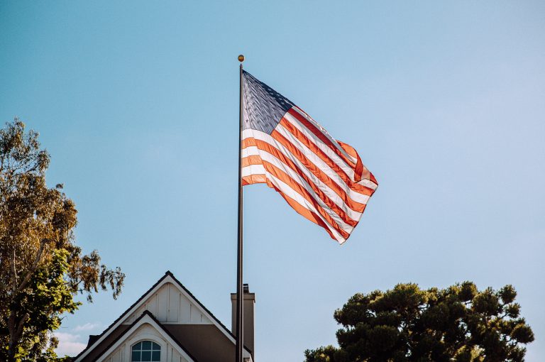 The American flag waving on pole.