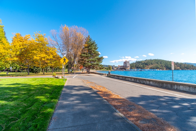 Autumn view of the lake, city beach, city park and downtown from the Fort Grounds waterfront area along the lake in Coeur d'Alene, Idaho, USA.
